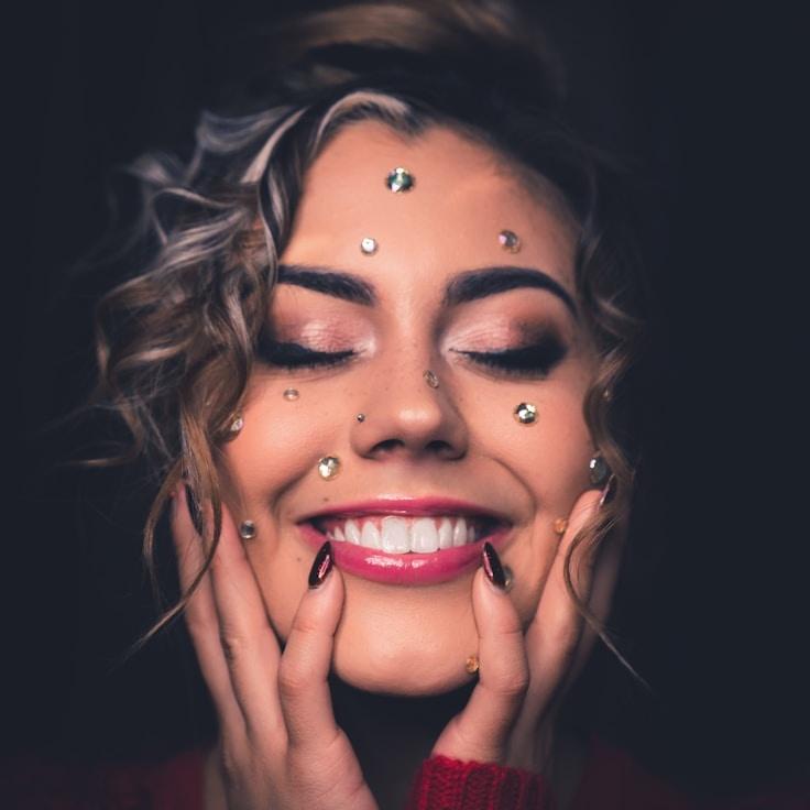 Avery Singh, Lead Design Curator at QuartzPaperGrove, reviewing corporate floral arrangements